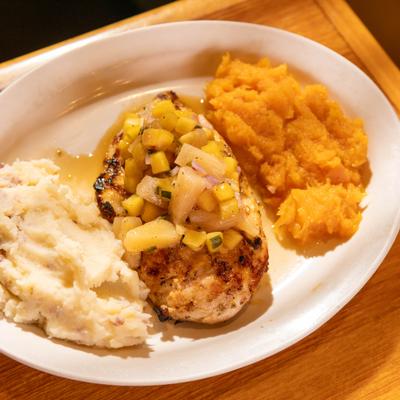 Chicken breast topped with pineapple mango salsa and side of mashed potatoes.