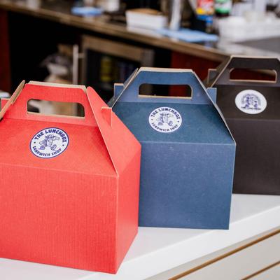Three colorful takeout boxes.