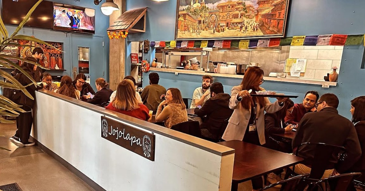 Indoor dining area with people seated at tables