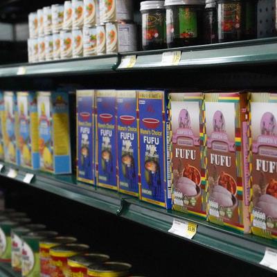 Product display Fufu flour and canned goods on a grocery store shelf.