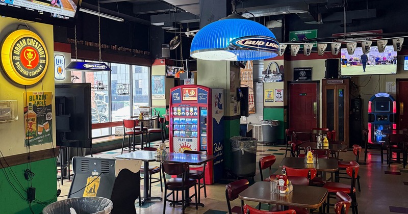 Interior with wooden tables, red chairs and retro decor.