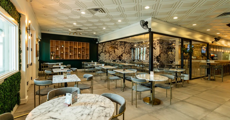 Interior, dining area, marble top tables with chairs, entrance on the left