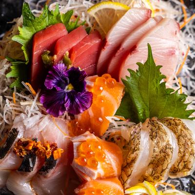 Close-up of assorted sashimi with salmon, tuna, and roe.