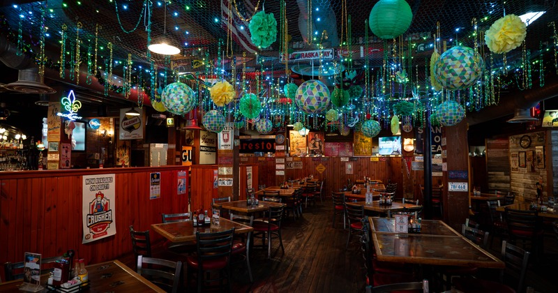 Interior, wooden tables and chairs, colorful lanterns and lights hanging from the ceiling
