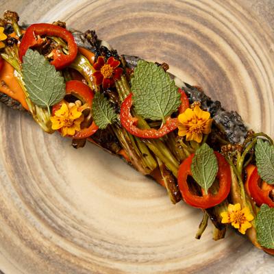 Large, blade-shaped quesadilla with various garnishes.