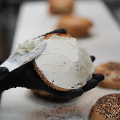Making a bagel sandwich.