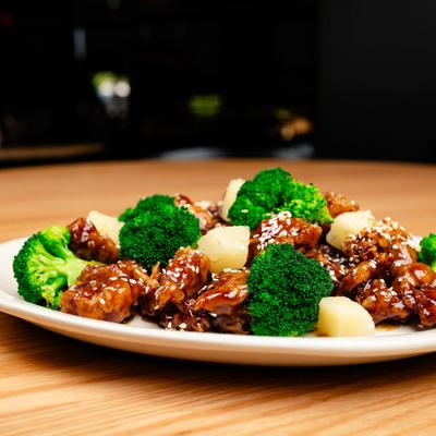 Sesame Chicken with broccoli and pineapple chunks.