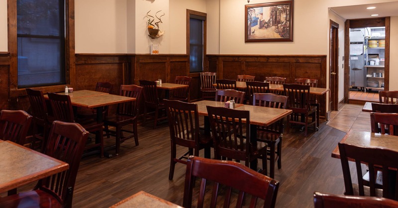 Interior, tables ready for guests, picture on the wall
