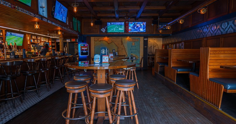 Interior, tables down the middle, bar on the left, seating booths on the right