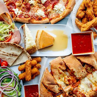 Assorted food dishes spread on the table, top view.