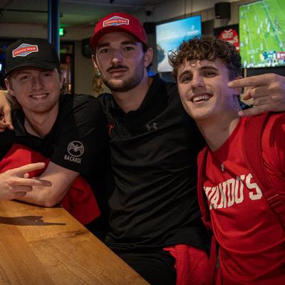 Guys at the bar posing.