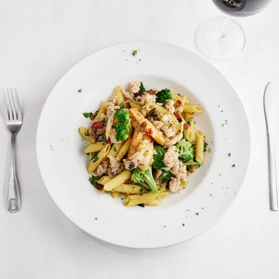 Seafood pasta paired with red wine, top down view.