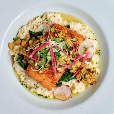 Roasted salmon on a bed of couscous and nuts, top view