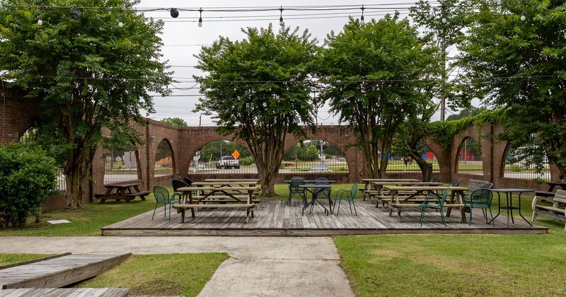 Exterior, wide view, patio, tables, chairs and benches