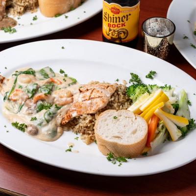 Blackened snapper in garlic cream sauce, with rice and vegetables.