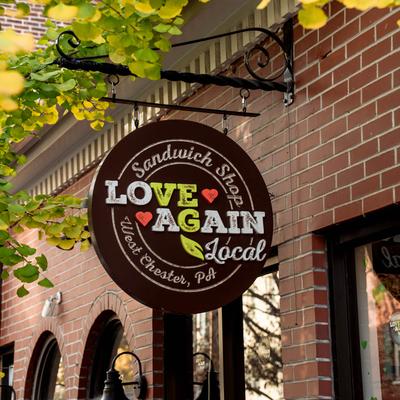 Love Again Local hanging sign  outside.