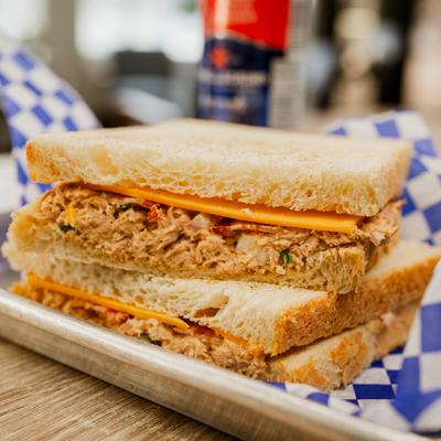 Tuna sandwich with bacon and cheddar cheese.