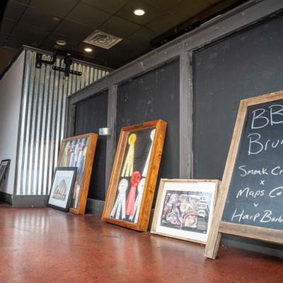 Interior, framed pictures, prize ribbons, and chalkboard menu.