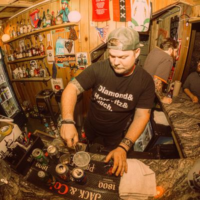 A bartender pouring a drink behind a bar counter