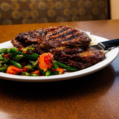 Grilled steak with green beans and carrots.