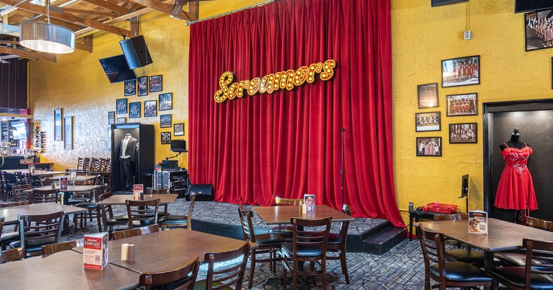 The stage at the center, tables and chairs around the stage