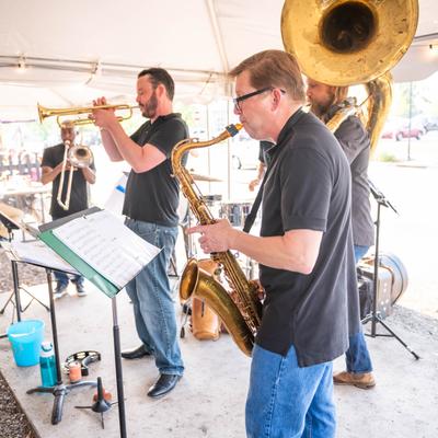 Brass band playing live for guests in the patio area.