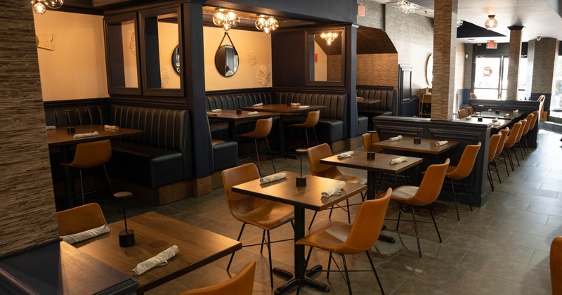 Interior, dining area, wooden top tables for two and four, comfy booths in the back