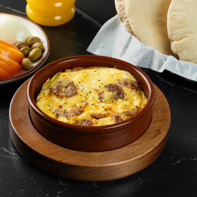 Eggs with spiced beef sausage served with bread.