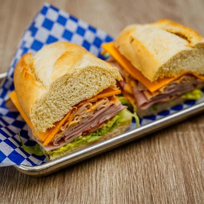 Ham and turkey sandwich with lettuce and spicy mayo.