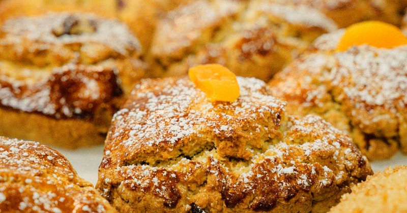Scones topped with powdered sugar and dried apricots