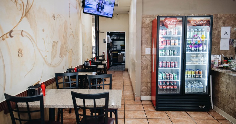 Interior, tables and chairs, TV on the wall