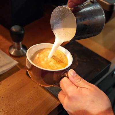 A barista preparing a latte.
