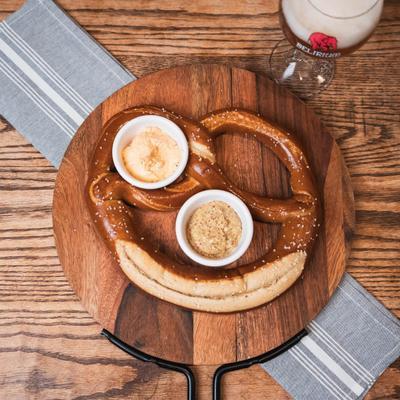Bavarian pretzel served with spicy obatzda and homemade mustard.