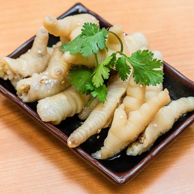 Chicken feet appetizer with cilantro garnish.