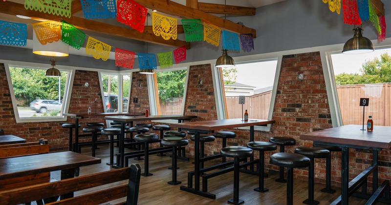 Interior space, seating area with high tables and round stools