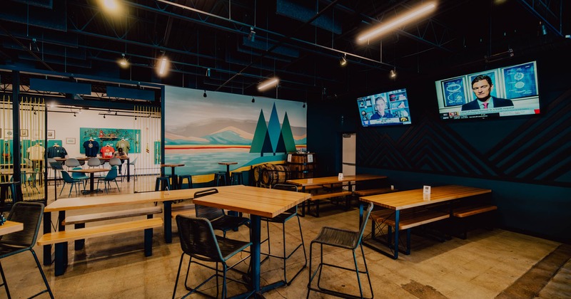 Interior, seating area, tables with benches, high seating tables, TVs on the wall