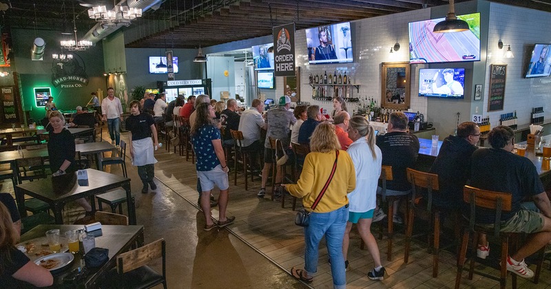 Interior space, seating area, and bar area full of guests