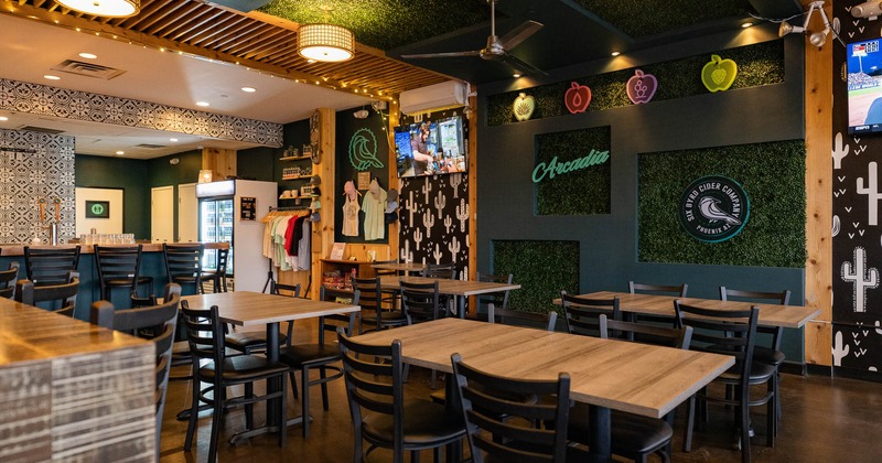 Interior, tables and chairs with decorated walls in background