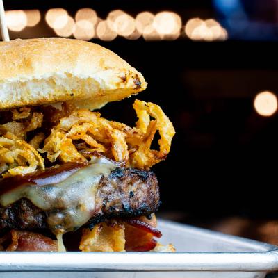 Western Burger topped with cheese, bacon, fried onion strings and BBQ sauce.