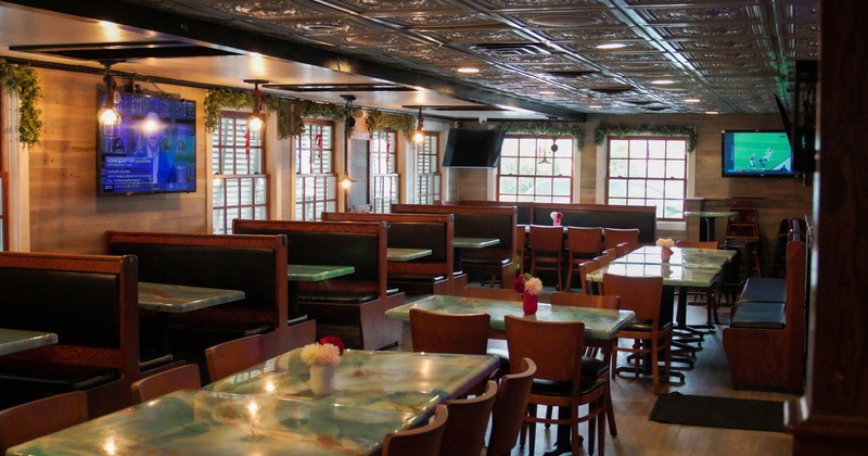 Interior, view of dining area, tv screens on the wall