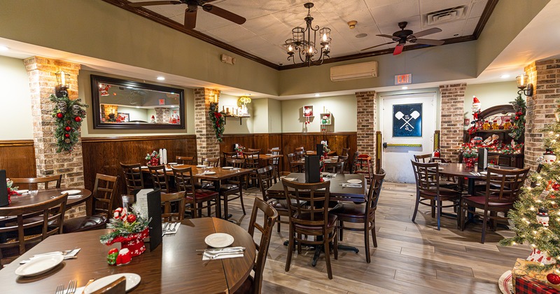 Restaurant interior, dining area with set tables, Christmas decoration