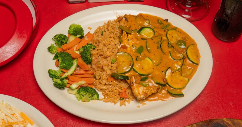 Chipotle zucchini chicken served with Mexican rice and steamed vegetables