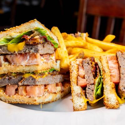 Cheeseburger club sandwich with BLT and fries.