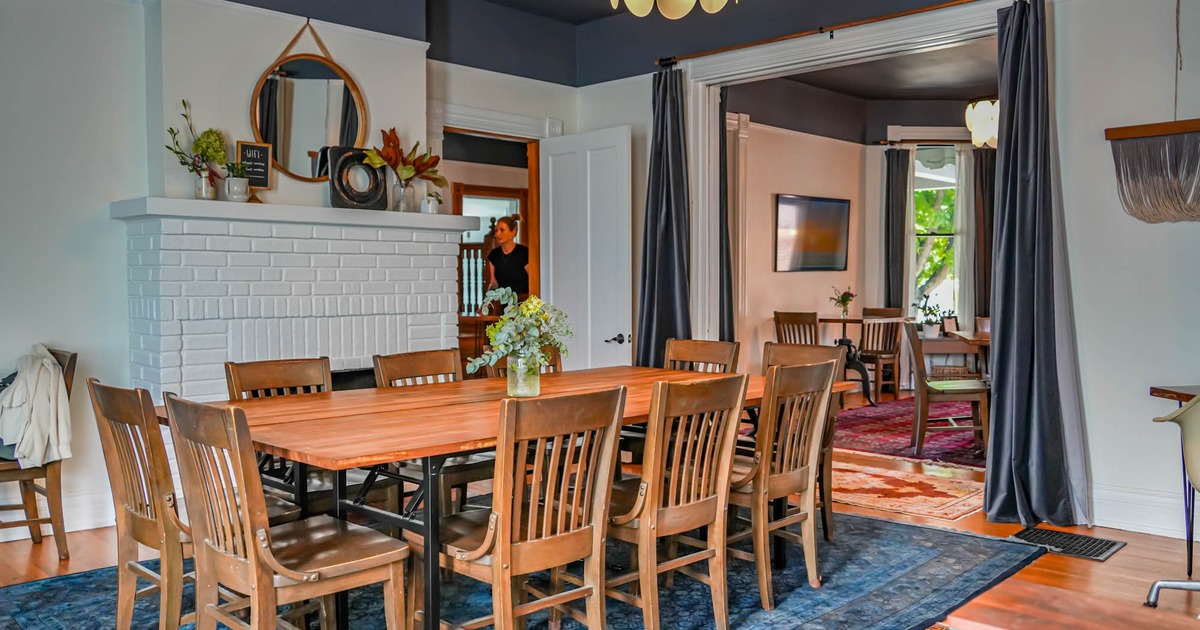 Interior, long wooden dining table, chairs, decoration