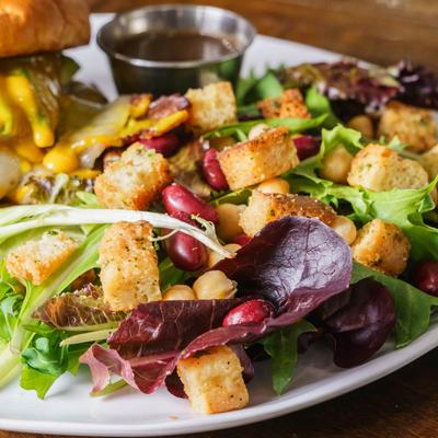 Side salad, with spring mix, focaccia croutons, and dressing.