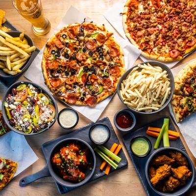 Various dishes served on the table with a glass of beer, overhead view.