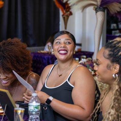 Group of people gathered together indoors, smiling and enjoying an event.