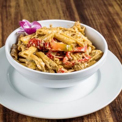 Rasta Pasta featuring penne pasta, bell peppers, onions and chicken.