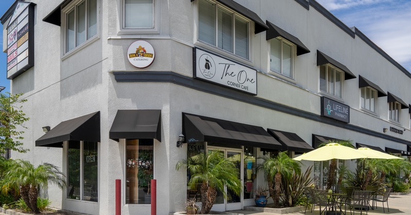Exterior, angle view to restaurant, entrance, tab;e, chairs, parasol