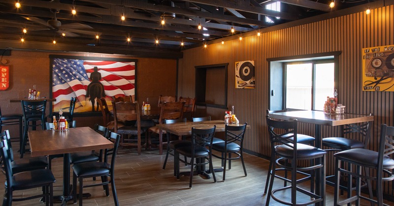 Diner area, tables, chairs, flag on the wall